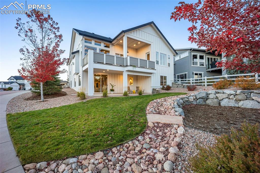 Image 45 of 50: Head outside to the back yard with its beautiful landscaping and covered pa