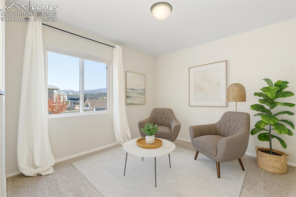 Image 20 of 42: Virtually Staged living area with carpet flooring