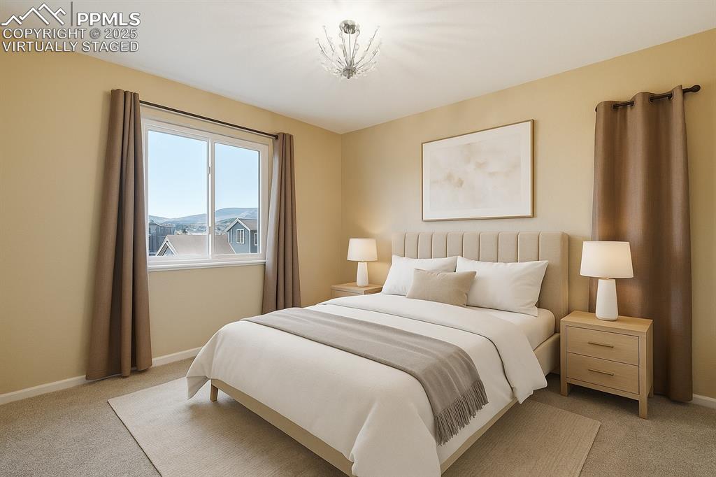 Image 27 of 42: Virtually Staged Bedroom featuring light colored carpet and baseboards