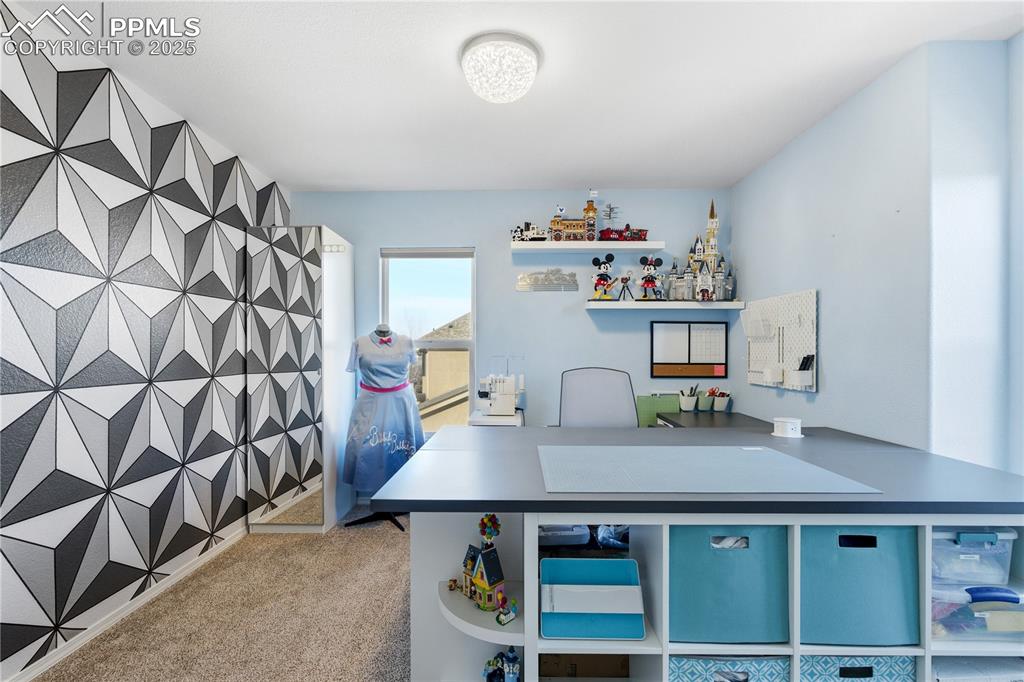 Image 29 of 42: Office space featuring light carpet and an accent wall