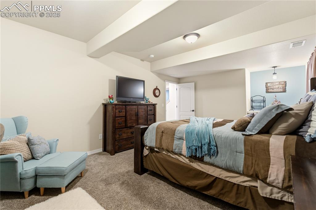 Image 34 of 42: Bedroom with light colored carpet and baseboards