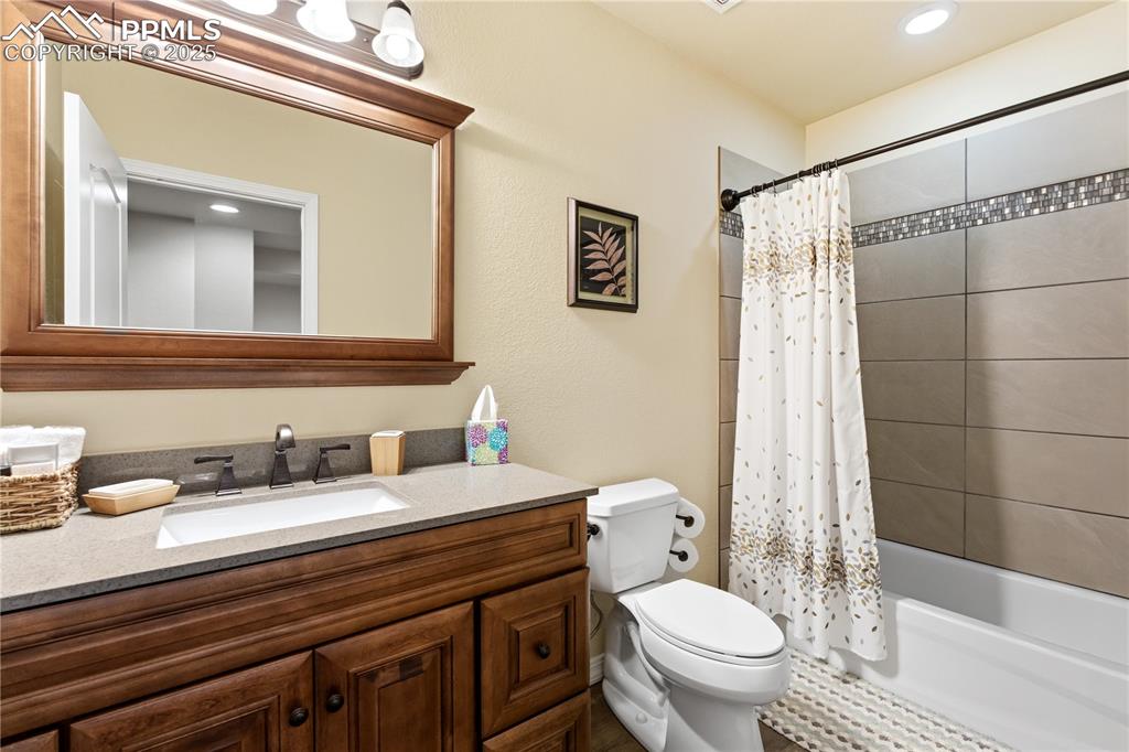 Image 35 of 42: Bathroom with shower / bath combination with curtain, recessed lighting, an