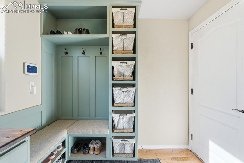 Image 36 of 42: Mudroom with light wood finished floors and baseboards