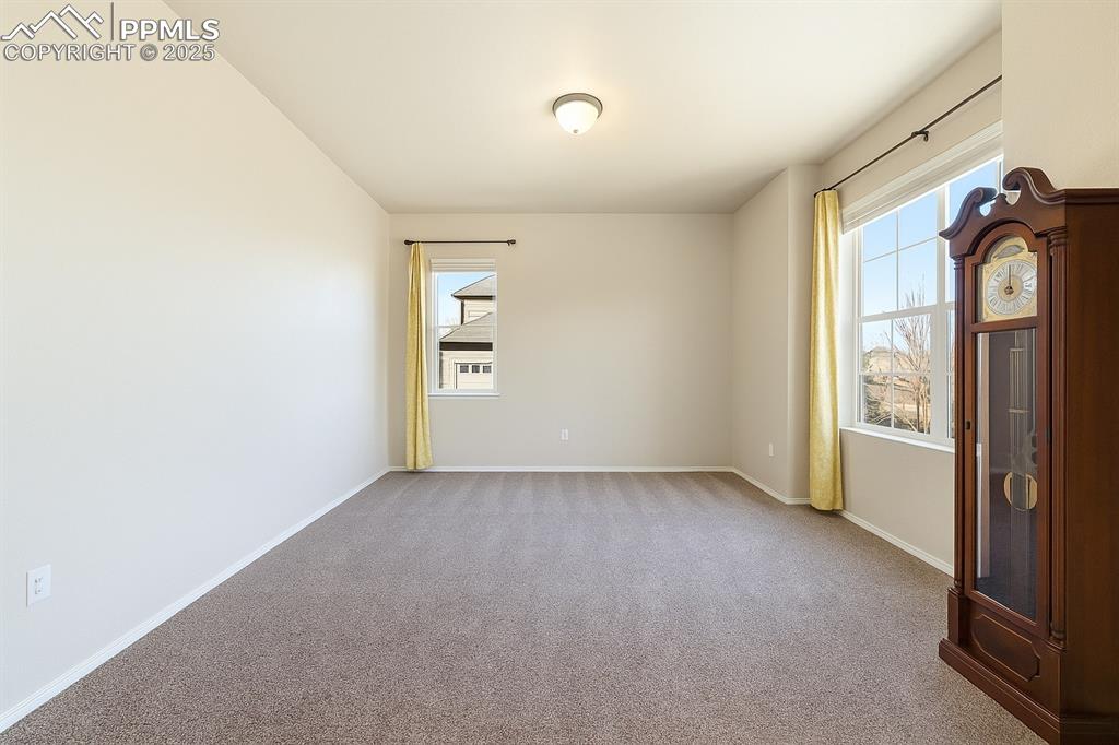 Image 6 of 42: Empty room featuring light carpet and baseboards
