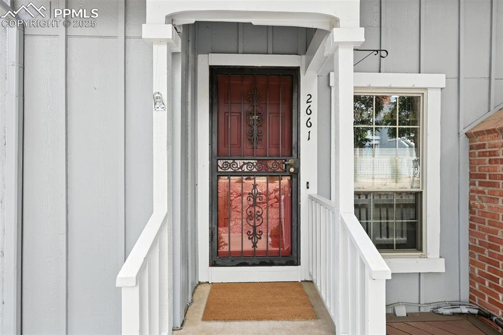 Image 2 of 25: Entrance to property with board and batten siding