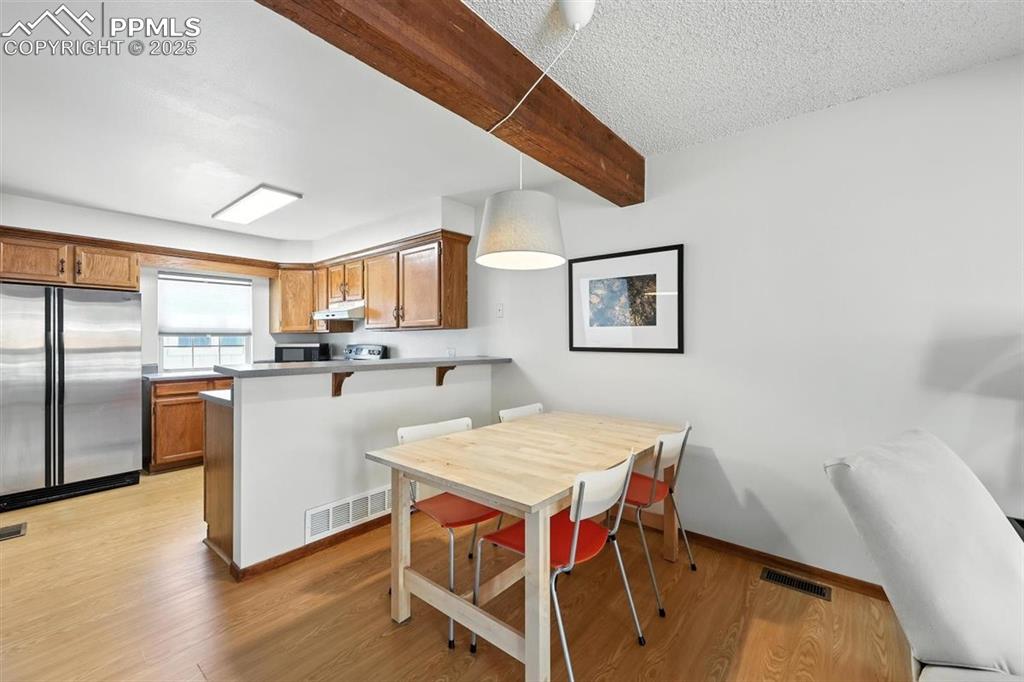 Image 6 of 25: Kitchen featuring appliances with stainless steel finishes, under cabinet r