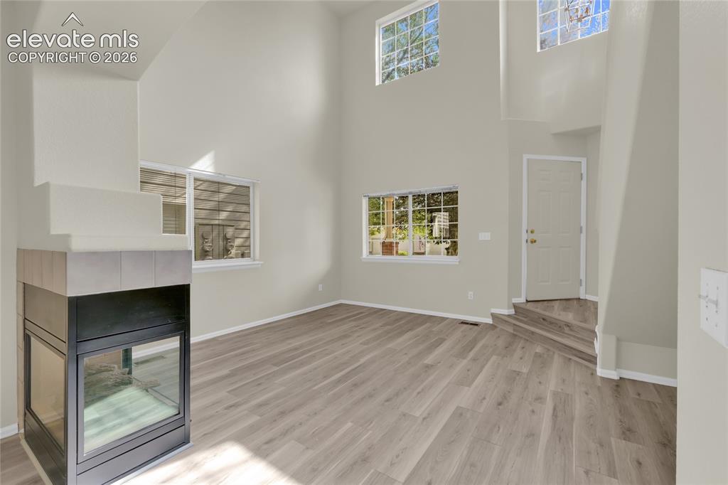 Image 10 of 30: Cathedral ceilings and fireplace