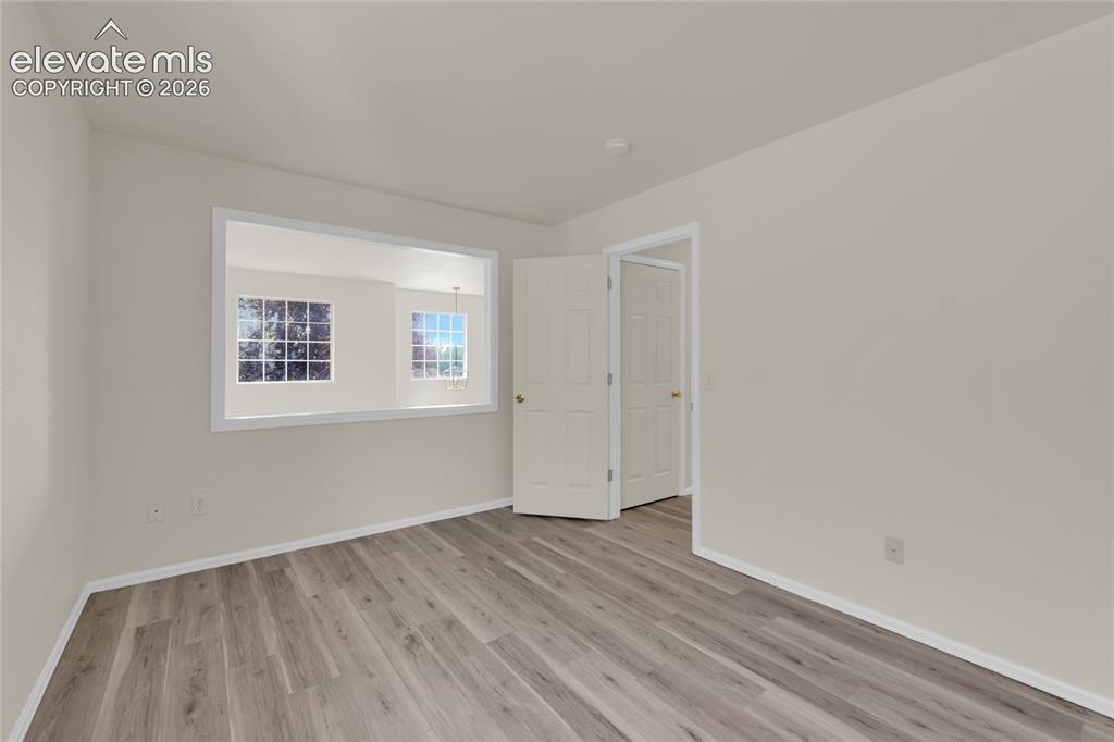 Image 16 of 30: Second bedroom over looking the living room