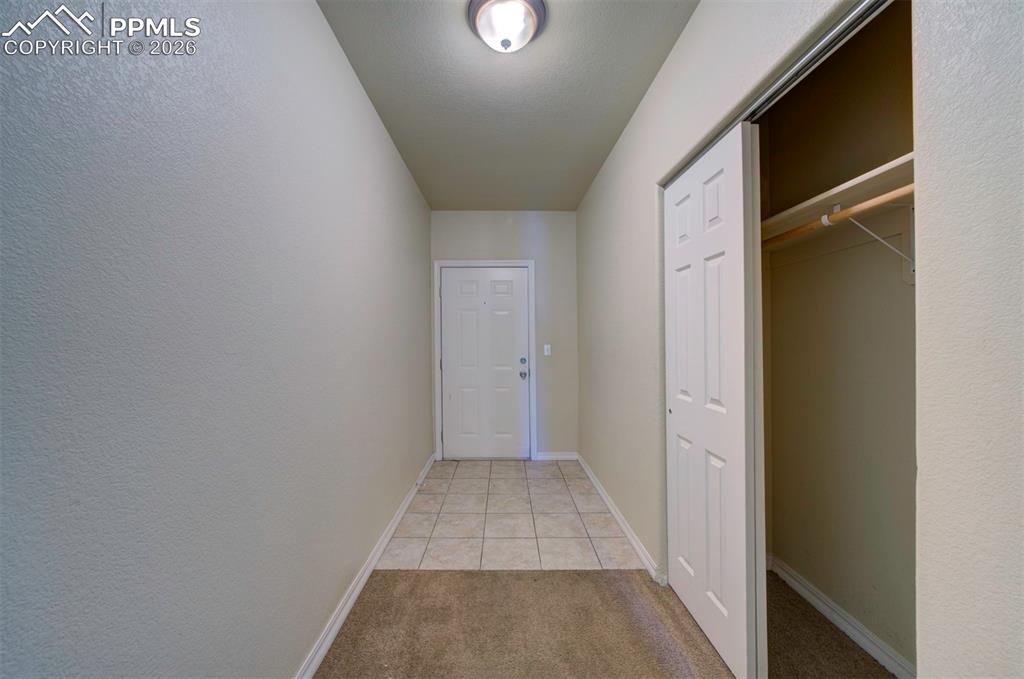 Image 3 of 36: Tiled foyer and coat closet