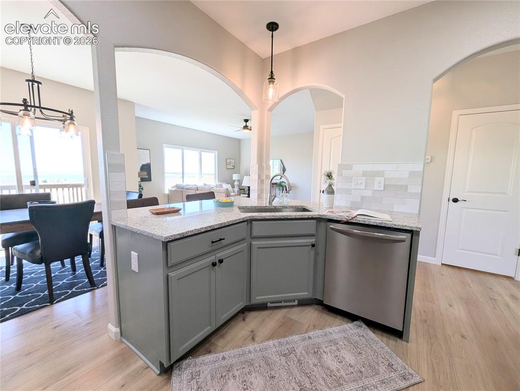 Image 10 of 49: Powder room featuring a single vanity with a dark countertop and cabinet st