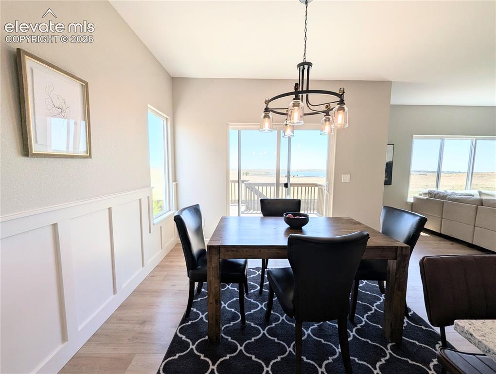 Image 12 of 49: Kitchen featuring light green cabinetry, granite countertops, and stainless