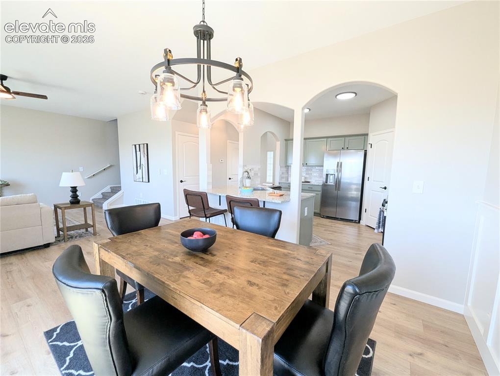 Image 14 of 49: Kitchen featuring light wood-finish flooring, gray cabinetry, speckled coun