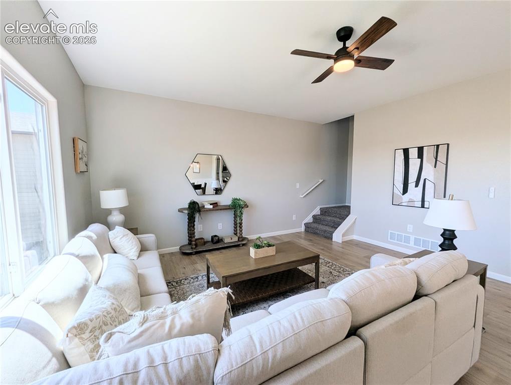 Image 17 of 49: Modern kitchen featuring light green cabinetry, stainless steel appliances,