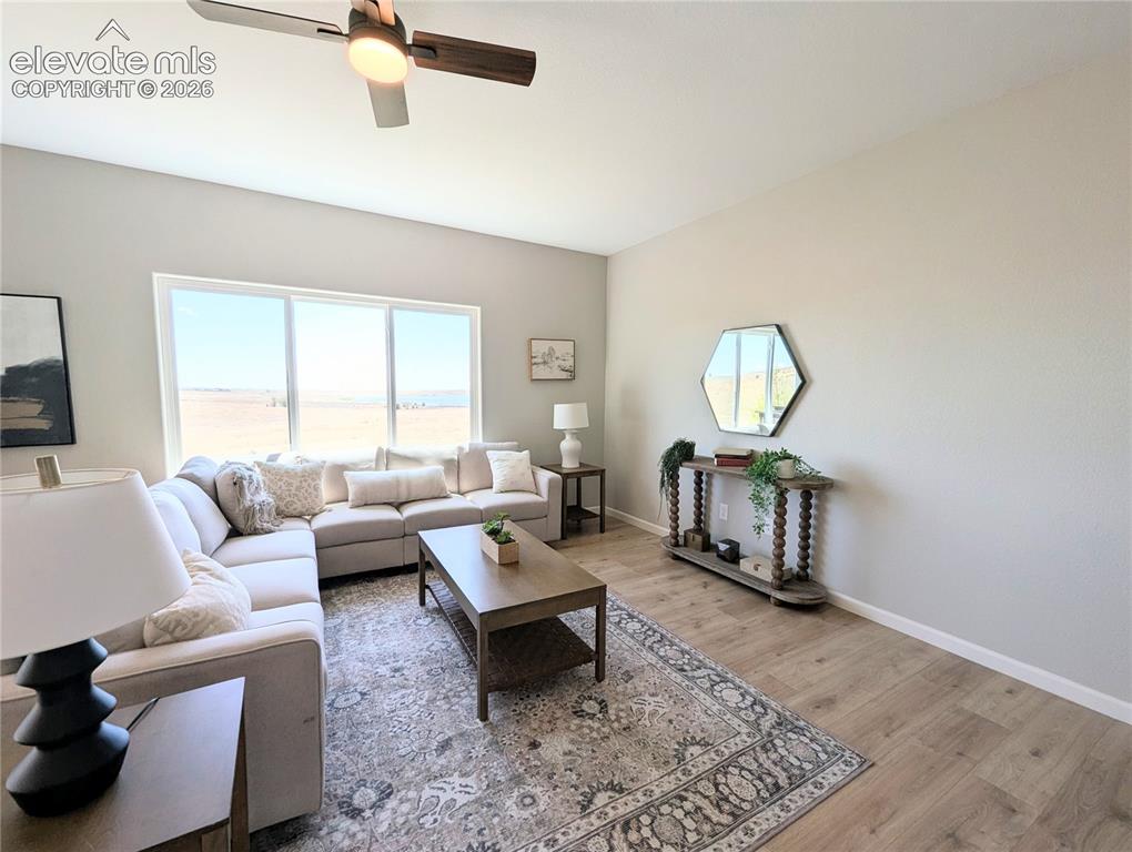 Image 18 of 49: Open-concept dining area featuring wood-finish flooring, a contemporary cha