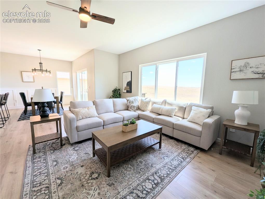 Image 19 of 49: Open-concept interior featuring wood-finish flooring, arched doorways, a br