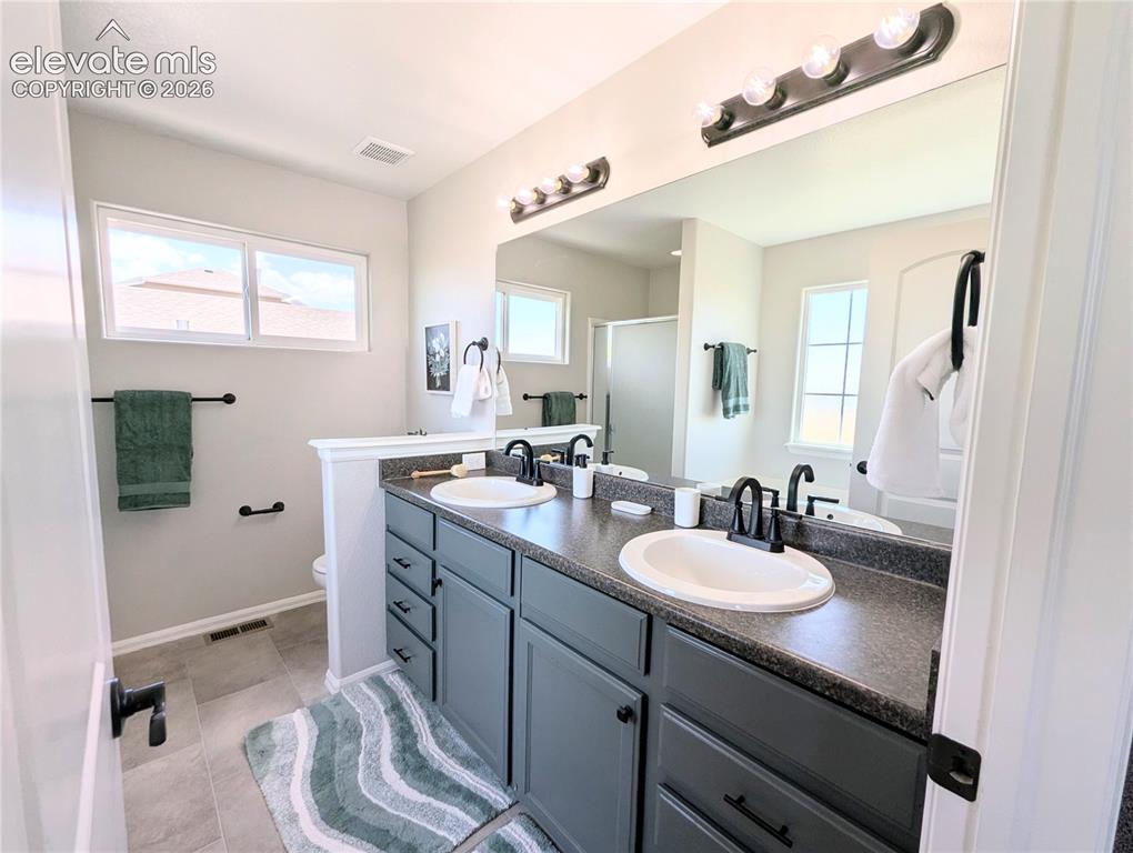 Image 29 of 49: Hallway with light gray walls, white trim, and gray speckled carpet