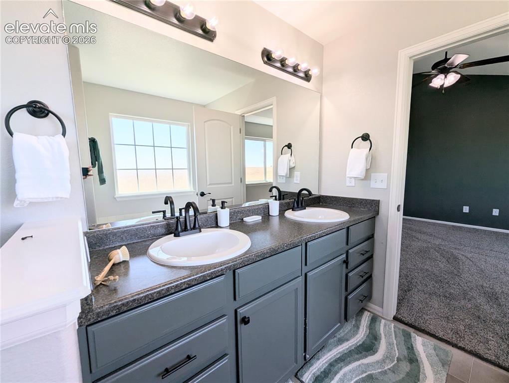 Image 30 of 49: Spacious room featuring vaulted ceilings, a contemporary ceiling fan, dual 