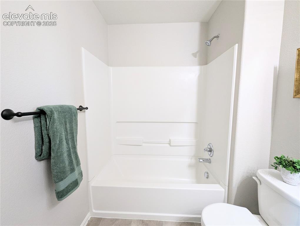 Image 39 of 49: Laundry area featuring a large window, wire shelving, and a built-in counte