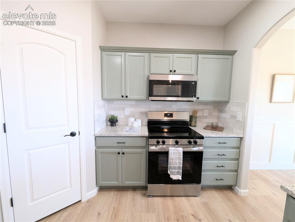 Image 9 of 49: Feature wall with decorative paneling and a neutral color palette