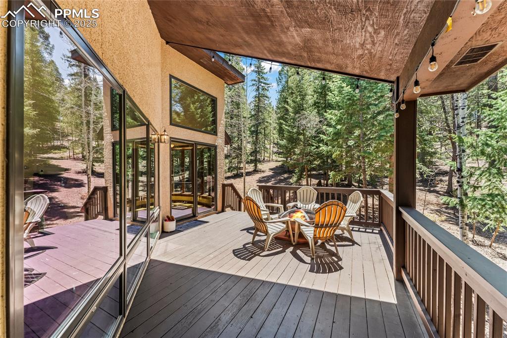 Image 11 of 49: Deck featuring view of wooded area