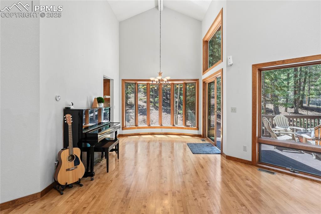 Image 2 of 49: Entrance foyer with a chandelier, plenty of natural light, wood finished fl