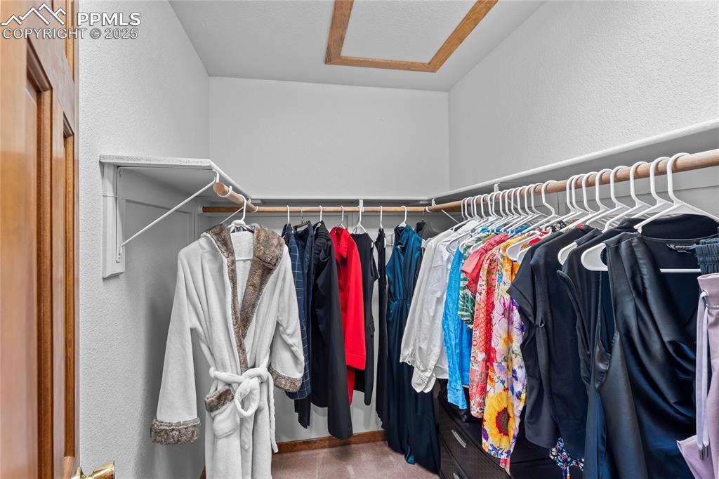 Image 21 of 49: Walk in closet with attic access