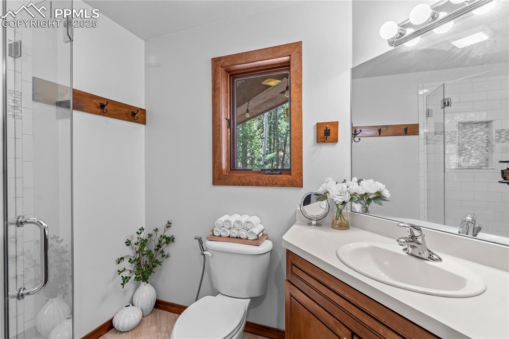 Image 22 of 49: Bathroom with a stall shower and vanity