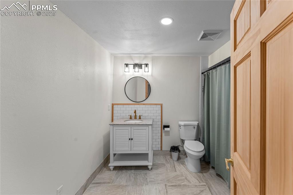 Image 30 of 49: Bathroom featuring vanity and a shower with curtain