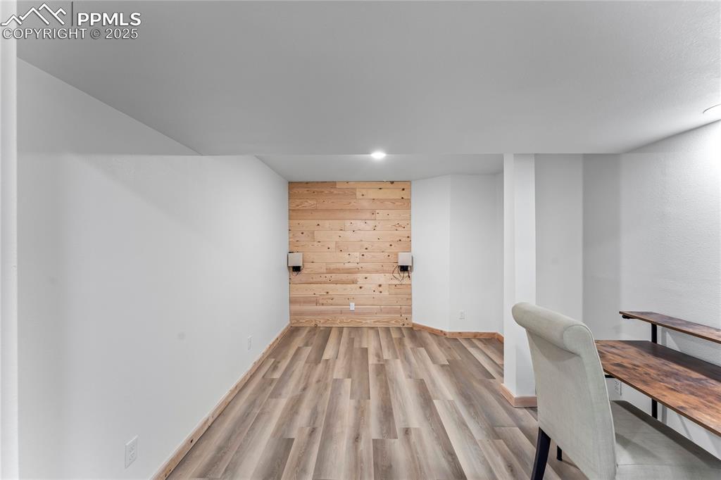 Image 34 of 49: Unfurnished office featuring light wood-style floors, wood walls, and reces