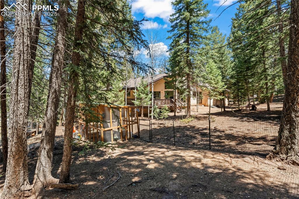 Image 39 of 49: View of yard with a wooden deck and a gate