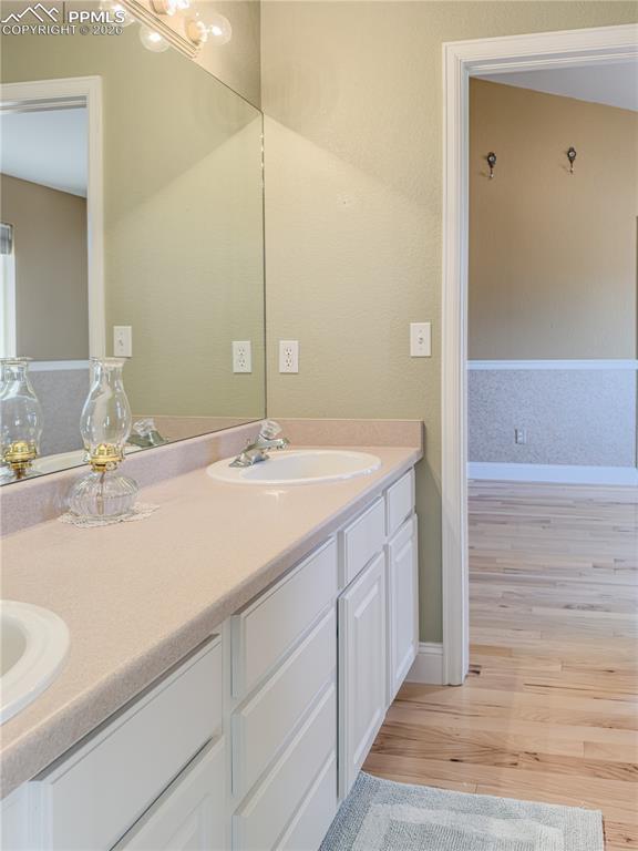 Image 21 of 50: "Jack-and-Jill" Main-level Full Bathroom featuring a double vanity and ligh