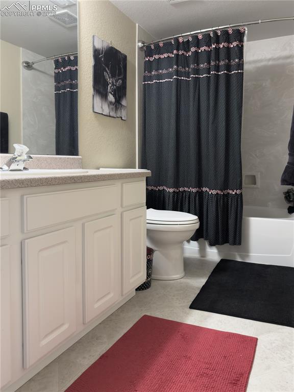 Image 34 of 50: Basement-level Bathroom with vanity, shower / bathtub combination with curt