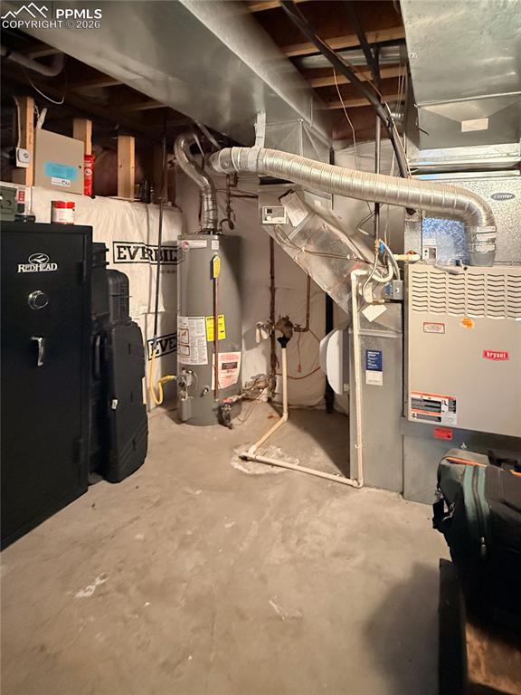 Image 35 of 50: Utility room featuring gas water heater, forced air heating/AC unit, and cr