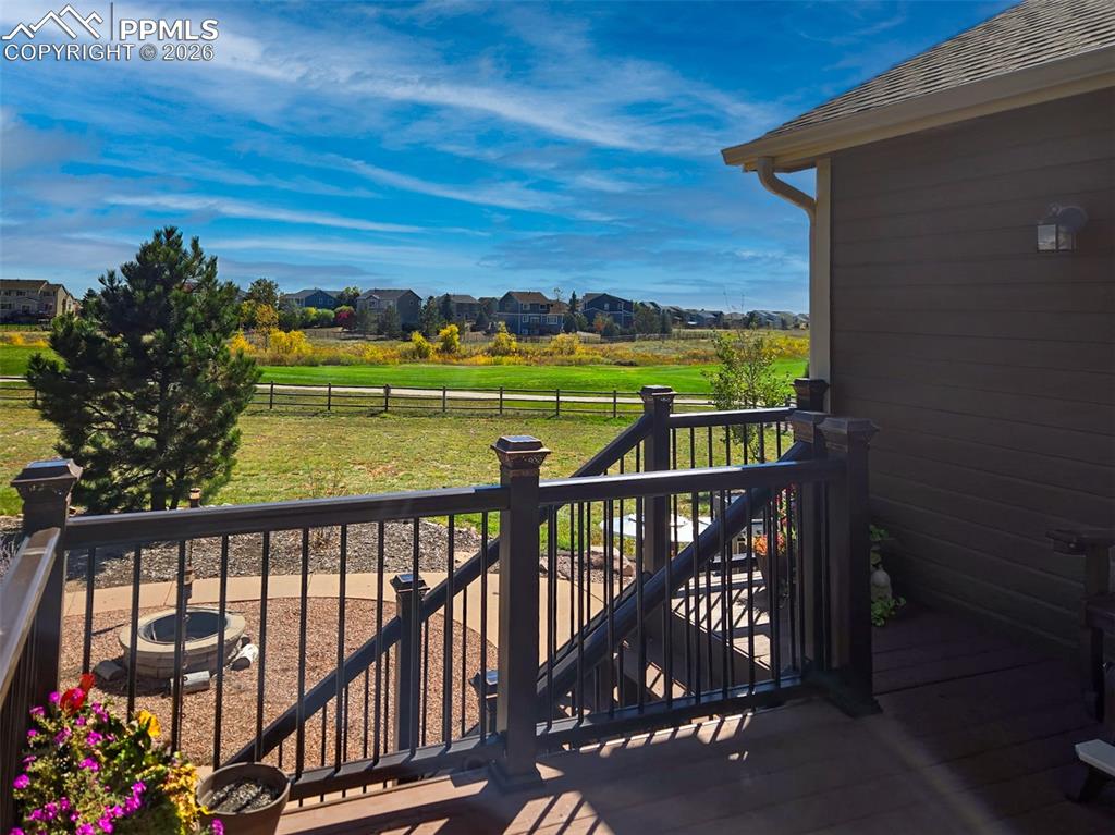 Image 37 of 50: View of wooden balcony with a residential view and a deck