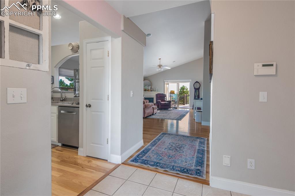 Image 4 of 50: Entry way opening to great room with fire place, adjacent dining area and s