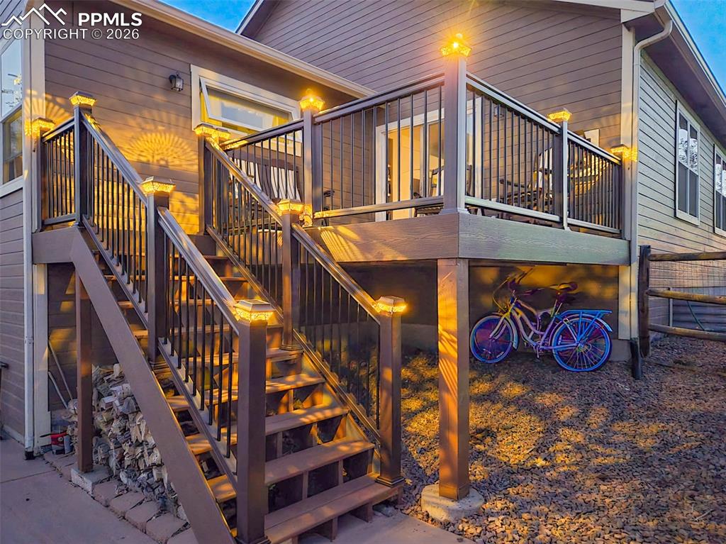 Image 40 of 50: View of property exterior featuring stairway and a deck