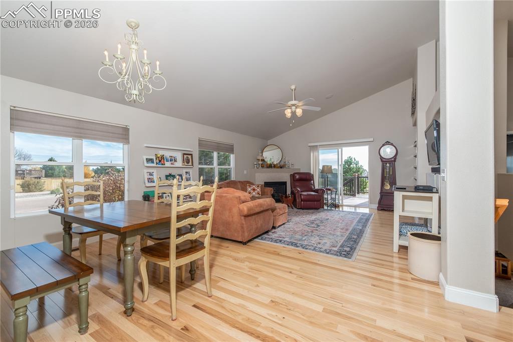 Image 7 of 50: Dining area featuring light wood finished floors, ceiling fan, a chandelier