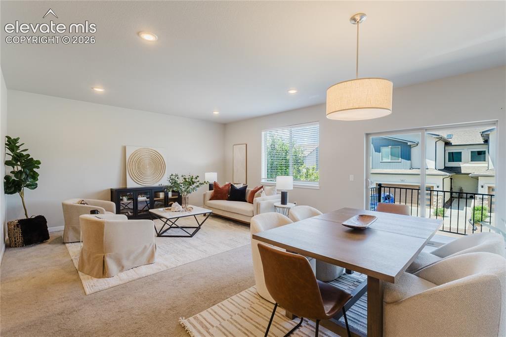 Image 5 of 21: Open-concept living and dining area featuring recessed lighting, a contempo