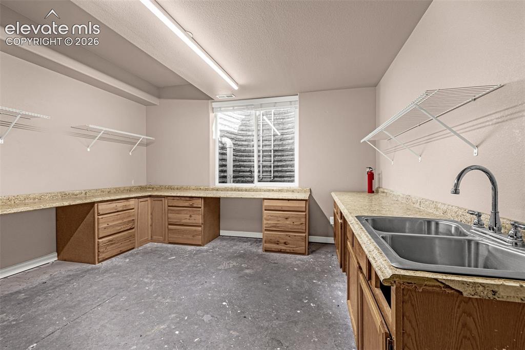Image 5 of 39: Basement bedroom, outfitted as a workspace