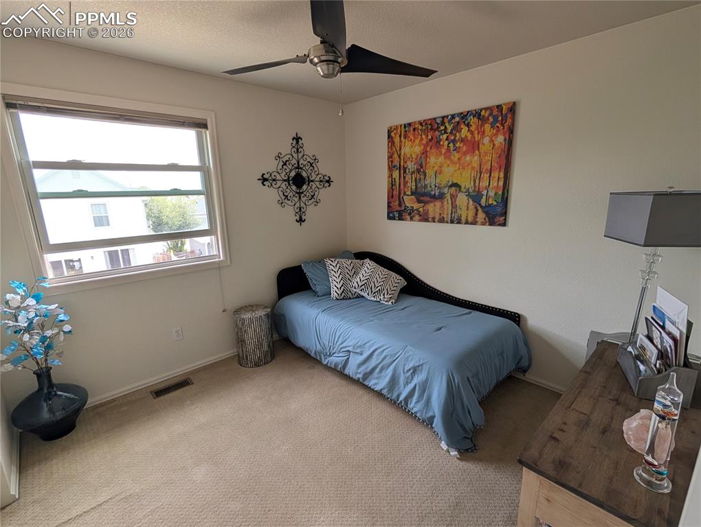 Image 15 of 30: bedroom 2 with ceiling fan and Anderson Windows
