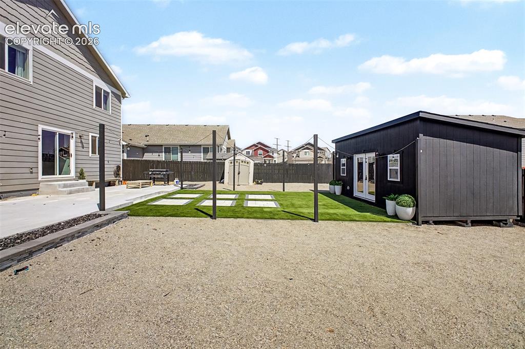 Image 12 of 39: Professionally Landscaped Backyard and Custom Shed