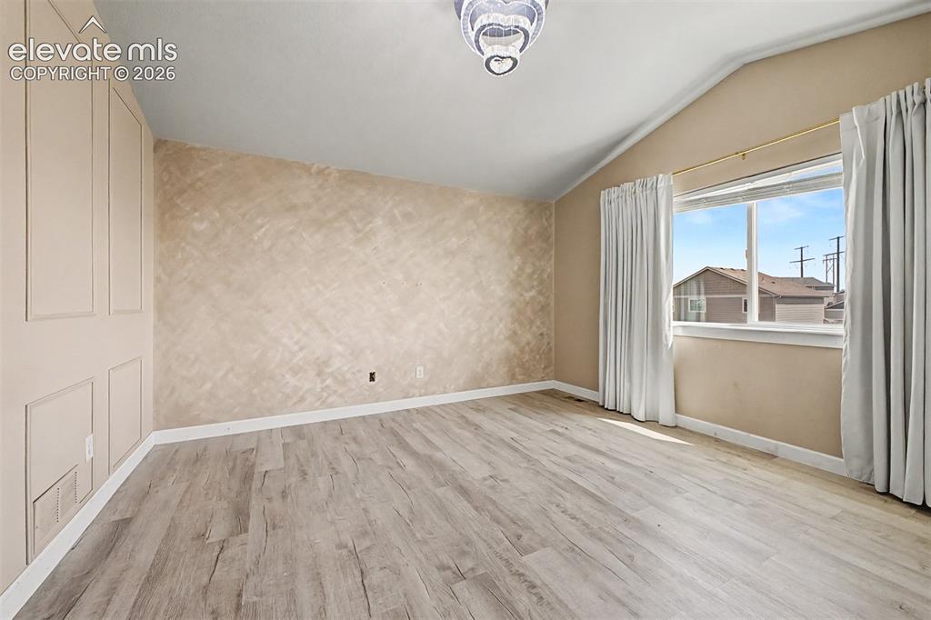 Image 22 of 39: Primary suite with vaulted ceiling