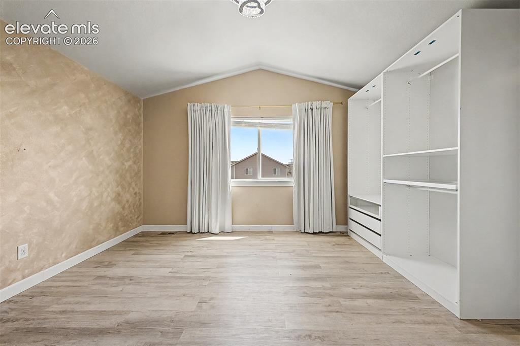 Image 23 of 39: Primary suite with vaulted ceiling