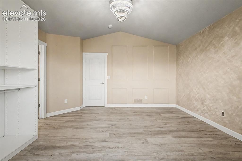 Image 24 of 39: Primary suite with vaulted ceiling