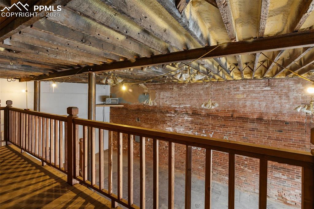 Image 11 of 34: Hallway featuring brick wall