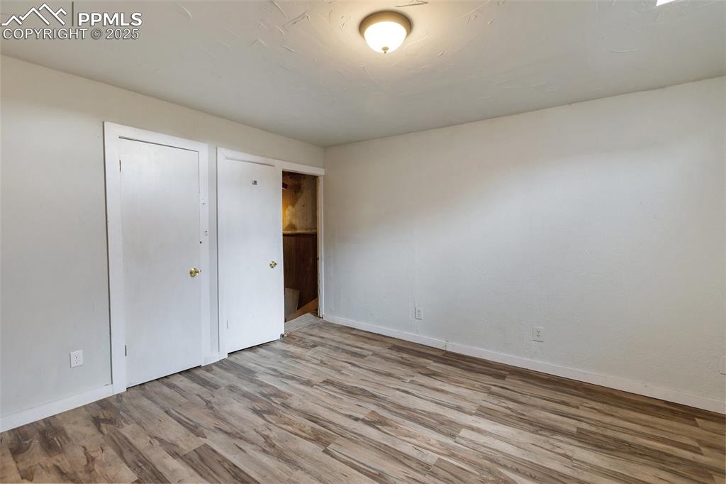 Image 13 of 34: Unfurnished bedroom with wood finished floors and a closet
