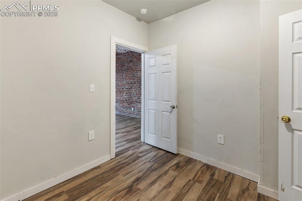 Image 16 of 34: Spare room with wood finished floors and baseboards