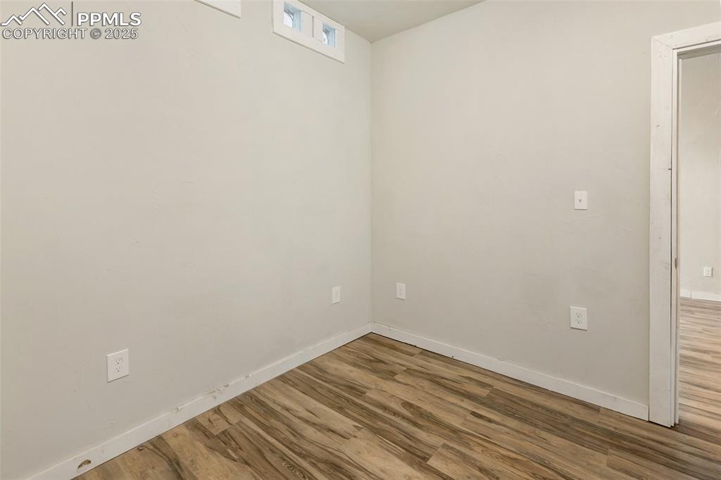 Image 17 of 34: Spare room with wood finished floors and baseboards