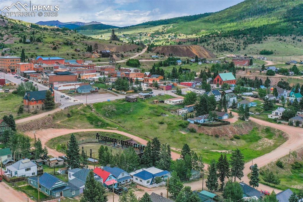 Image 3 of 34: Aerial perspective of suburban area featuring a mountain backdrop