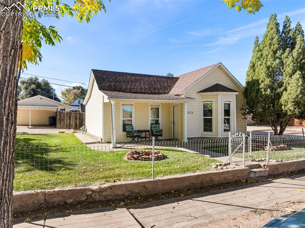 Image 37 of 39: View of front of house featuring roof with shingles, a fenced front yard, a